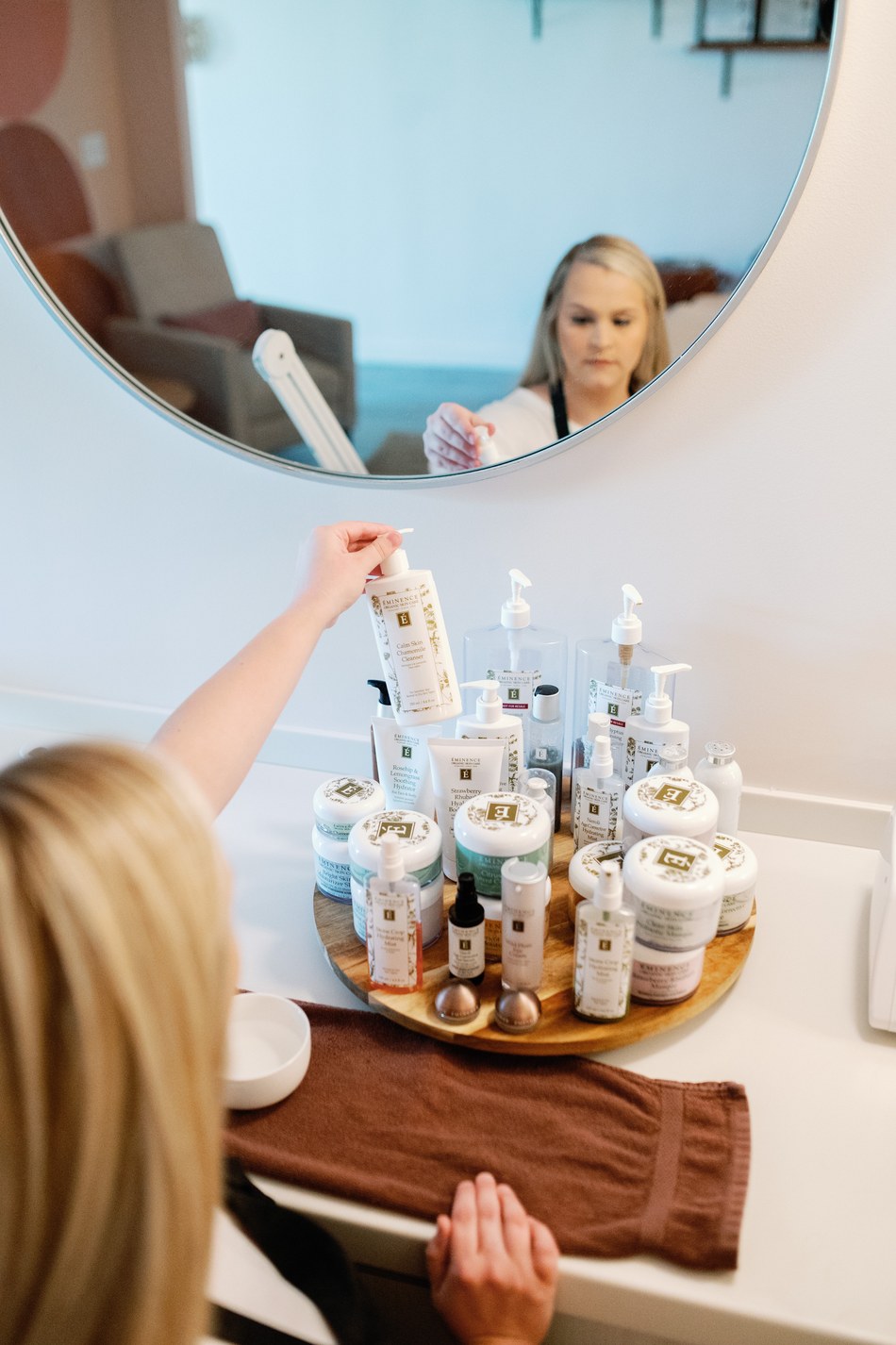 A guest selects an Éminence product at the mirror
