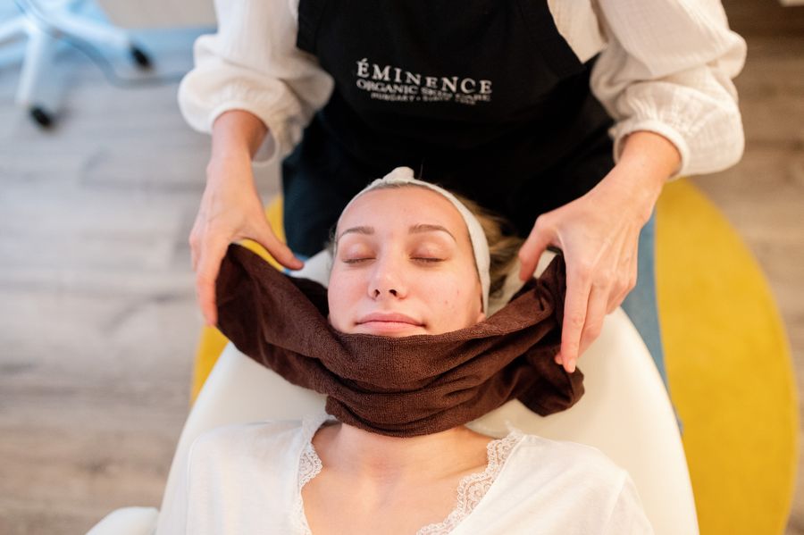 Magen performing a facial treatment