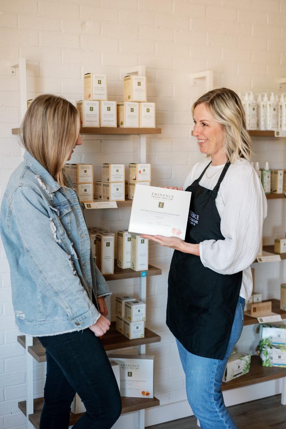An esthetician presents an Éminence gift set